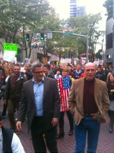 Occupy Portland Sam Adams and Randy Leonard marching with them.