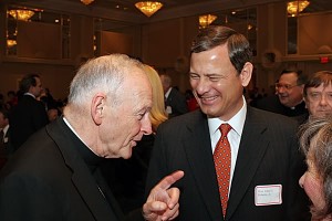 Chief Justice John Roberts shares a laugh with Cardinal Theodore McCarrick