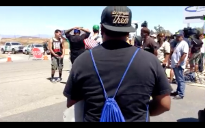 Counter protester at Murrieta Border Patrol station held a sign which read, "Migration is a Human Right."