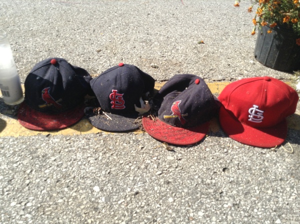Baseball caps, like the one Michael Brown was wearing the night of his death, line the memorial at the spot where he died August 9th.  Photo: Victoria Taft, VictoriaTaft.com